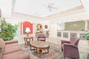 a living room with purple chairs and a table at Baymont by Wyndham Crestview in Crestview