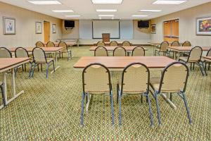 a classroom with tables and chairs in a room at Baymont by Wyndham Indianapolis West in Indianapolis
