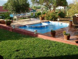 a swimming pool in the backyard of a house at Clos Benoit, A Vineyard Inn in El Porvenir