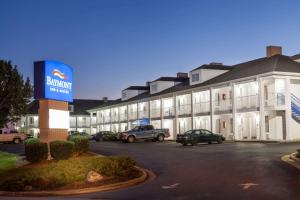 a building with cars parked in a parking lot at Baymont by Wyndham Hickory in Hickory