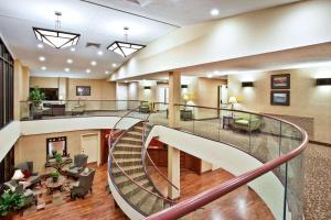 a lobby with a spiral staircase in a hospital at Baymont by Wyndham Knoxville/Cedar Bluff in Knoxville +29 photos