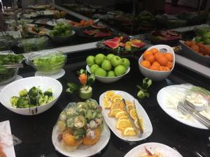 a buffet with plates of food and bowls of fruits and vegetables at Grand Kayalar Hotel in Antalya