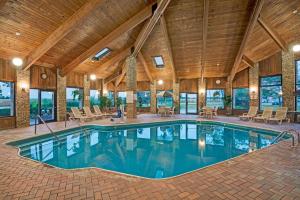 an indoor pool in a house with a wooden ceiling at Baymont by Wyndham Washington Court House in Jeffersonville