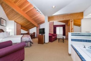 ein Hotelzimmer mit einem Bett und einem Bad in der Unterkunft Baymont by Wyndham Marshfield in Marshfield