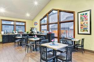 a restaurant with tables and chairs in a room at Baymont by Wyndham Provo River in Provo