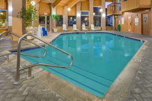 a swimming pool in a hotel with blue water at Baymont by Wyndham Yreka in Yreka