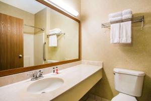 a bathroom with a sink and a toilet and a mirror at Baymont by Wyndham Helena in Helena +22 photos