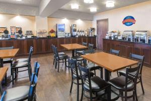 a restaurant with tables and chairs and a counter at Baymont by Wyndham Bartonsville Poconos in Bartonsville