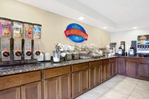 a restaurant with a buffet line with aperature at Baymont Inn & Suites by Wyndham San Marcos in San Marcos