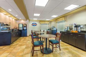 a restaurant with tables and chairs in a cafeteria at Baymont by Wyndham Cornelia in Cornelia