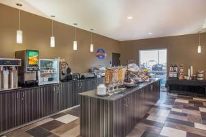 a restaurant with a counter with food on it at Baymont by Wyndham Grand Forks in Grand Forks