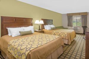 a hotel room with two beds and a window at Baymont by Wyndham Ames in Ames +18 photos