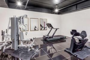 a gym with two treadmills and two exercise bikes at Baymont by Wyndham Delavan Near Lake Geneva in Delavan