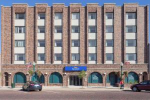 a large brick building with cars parked in front of it at Baymont by Wyndham Delavan Near Lake Geneva in Delavan