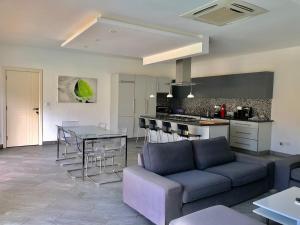 a living room and kitchen with a couch and a table at Amber Villas Diani in Diani Beach