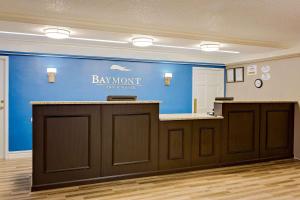 a bar in a dental office with a blue wall at Baymont by Wyndham Jacksonville Orange Park in Jacksonville