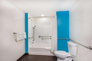 a bathroom with a toilet and a shower stall at Howard Johnson by Wyndham Quincy/ Boston in Quincy