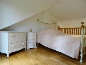 a bedroom with a bed and a white dresser at Batley House in Westgate-on-Sea