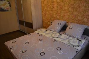 a bed in a small room with two pillows at Гагарин in Pyatigorsk