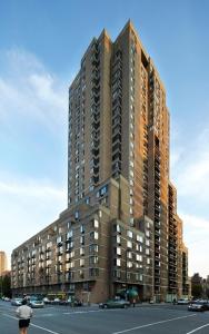 a large tall building in the middle of a street at LaCité Cozy Apartment Close to Central Montreal in Montréal