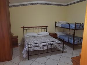 a bedroom with two bunk beds in a room at Agriturismo La Selva in Cava deʼ Tirreni