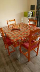 a wooden table with chairs and a tableasteryasteryasteryasteryasteryasteryasteryastery at Naramanue in Dorgali