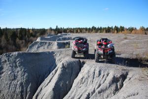 two atvsikers riding on rocks on a dirt road at Tsar Gory Guest House in Ruskeala