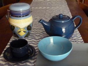 a table with a tea pot and a bowl on a table at La Canàoula in Bobbio Pellice