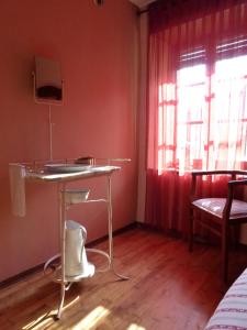 a small room with a table and a window at La Canàoula in Bobbio Pellice