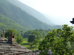 a view of a valley with mountains in the background at La Canàoula in Bobbio Pellice