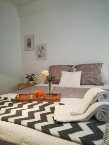 a bedroom with a bed with a table with a blanket at Liberdadeflat4u in Braga