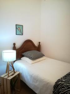 a bedroom with two beds and a lamp on a table at Liberdadeflat4u in Braga