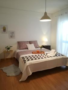 a bedroom with a bed with a table on it at Liberdadeflat4u in Braga