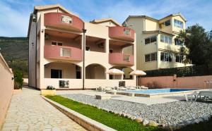 a large apartment building with a swimming pool at Apartmani Bulajic in Tivat
