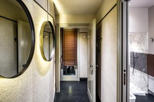 a hallway with a mirror on the wall at Locanda Pandenus Brera in Milan