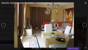 a living room with a couch and a dining room at Apartamento Marbella Playa in Marbella