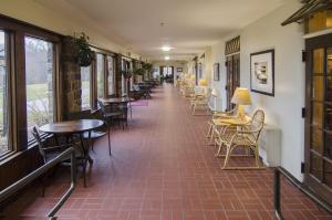 a corridor of a restaurant with tables and chairs at Potawatomi Inn & Cabins in Angola
