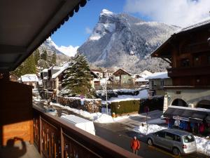 a view of a snow covered mountain from a balcony at Résidence Flor'alp in Samoëns