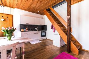 a kitchen with a wooden staircase in a room at Ula's Holiday Apartments in Beatenberg