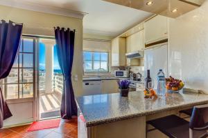 a kitchen with a counter with a view of the ocean at Vau Seaview Apartment in Portimão