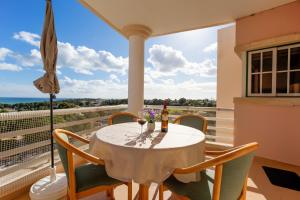 a table and chairs on a balcony with a view of the ocean at Vau Seaview Apartment in Portimão