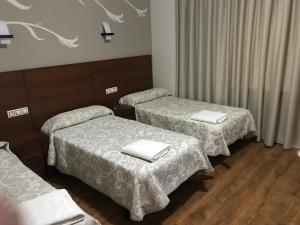 Postel nebo postele na pokoji v ubytování Hostal Juli
