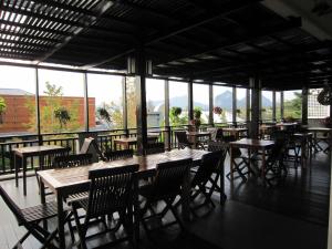 an empty restaurant with tables and chairs and windows at Royal Nakara Ao Nang in Ao Nang Beach