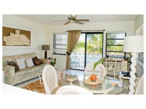 a living room with a couch and a table and chairs at 8 Villa Martinique in Freeport