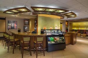 a restaurant with a bar and a pinball machine at Hyatt Place El Paso Airport in El Paso