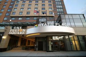 a building with an american flag in front of it at Hyatt Place Flushing/LGA Airport in Queens