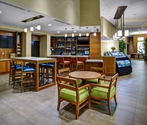 a dining room with chairs and tables in it at Hyatt Place Delray Beach in Delray Beach