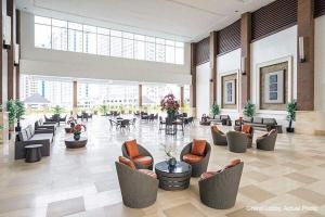 a large lobby with couches and chairs and tables at Elizabeth 1829 @ Wind Residences in Tagaytay