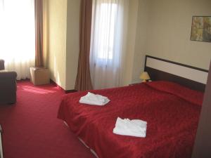 Voodi või voodid majutusasutuse Apart Hotel Comfort toas