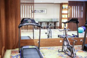 a gym with two bikes parked in front of a mirror at SSAW Boutique Hotel Hangzhou Qiandao Lake in Chun'an